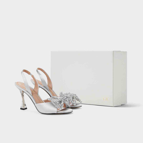 CHARLES&KEITH silver satin heeled sandals with beaded bow and glass heel for weddings and elegant occasions