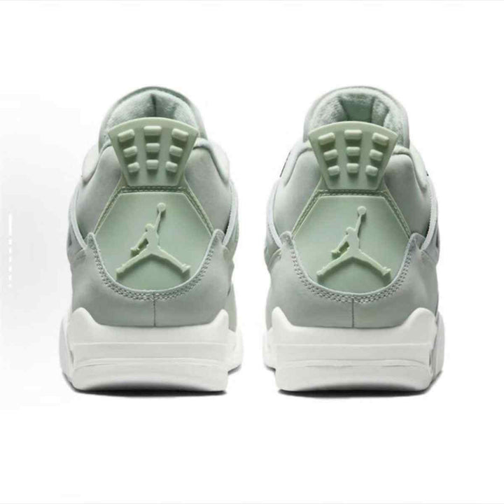 Air Jordan 4 Retro Seafoam sneakers with iconic light green and metallic silver accents.
