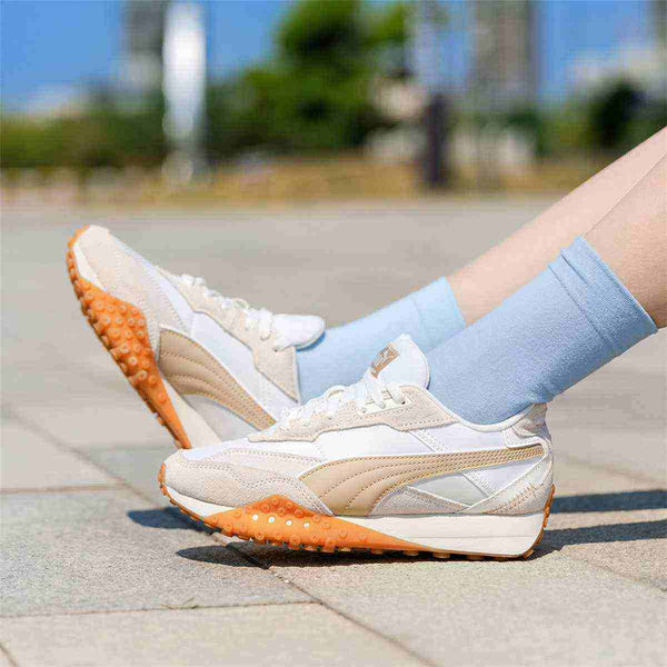 Puma Track Sneakers in white and light beige with beige side logo and rubber outsole, perfect for casual style.