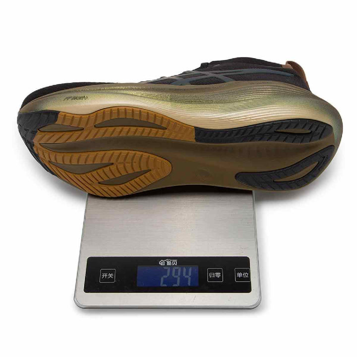 ASICS Gel-Nimbus 27 shoe with innovative outsole on scale displaying weight.