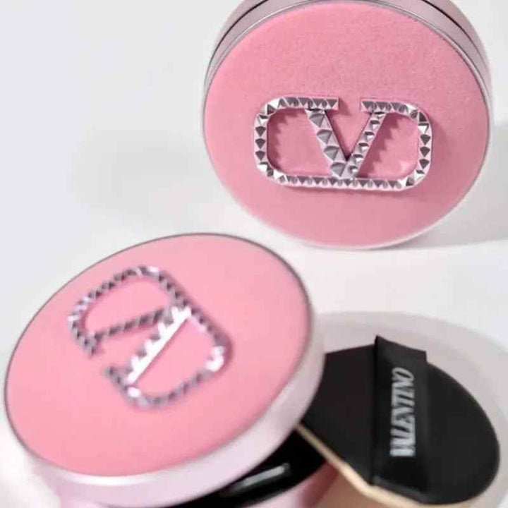 Pink Valentino Beauty Limited foundation cream compact with silver CV logo and applicator sponge.