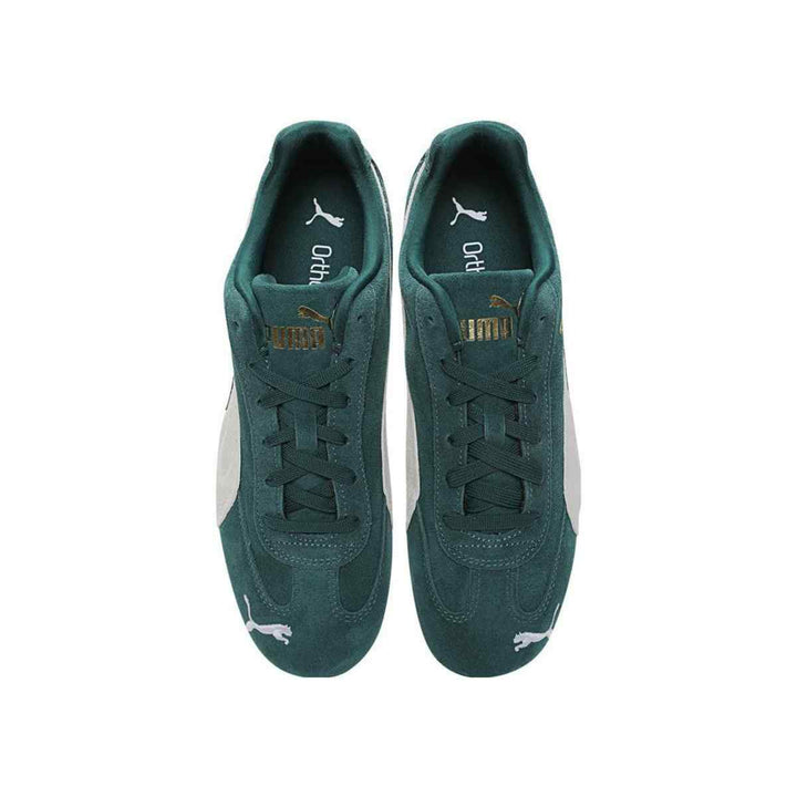 Puma Speedcat OG sneakers in green suede with gold logo and black rubber sole, top view.