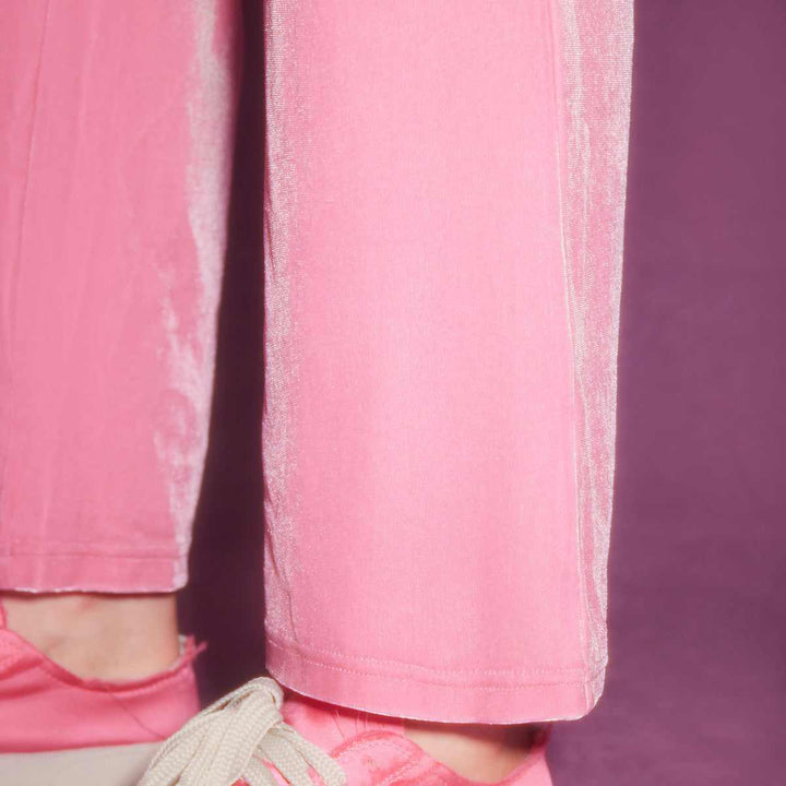 Juicy Couture pink velour pants with embroidered logo and elastic waistband.