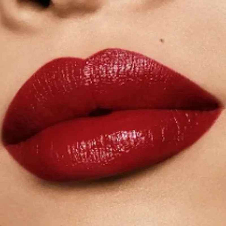 Close-up of smooth, satin-finish lips wearing deep red Guerlain Lucky Gold limited edition gemstone lipstick.