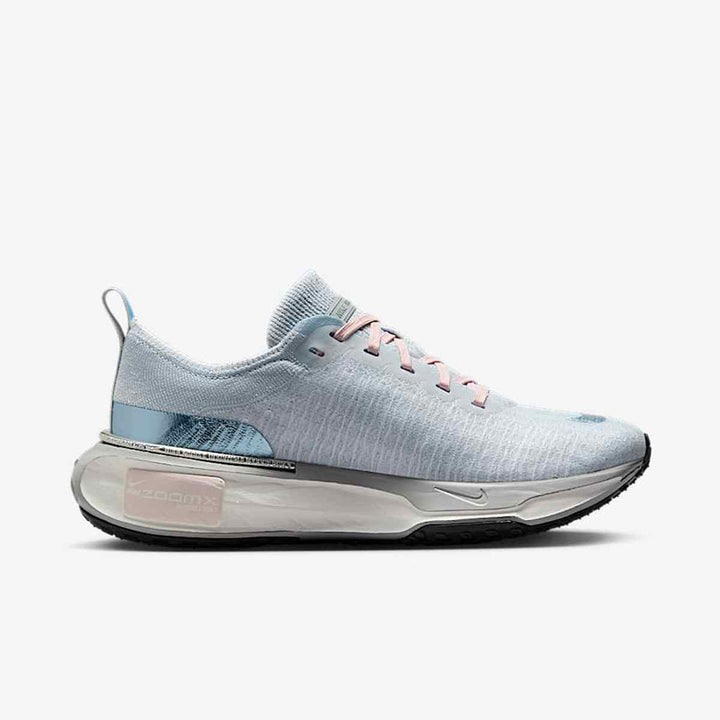 Light blue Nike ZoomX Vaporfly running shoes with mesh upper and reflective logo.