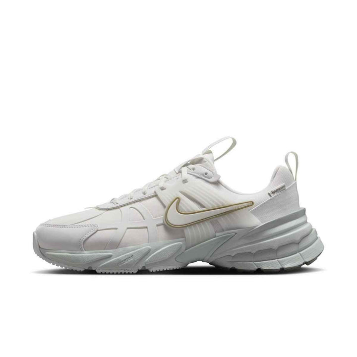 White and pale green Nike Zoom 5 sneaker with modern design and Zoom Air technology.