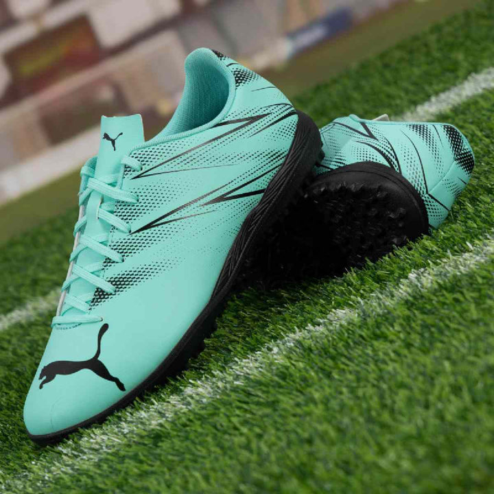 Puma football shoes in turquoise and black for artificial grass surfaces.