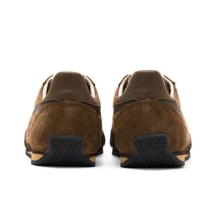 Rear view of brown luxurious leather Asics Onitsuka Tiger Mexico 66 shoes with iconic side logo and flexible sole for comfort and style