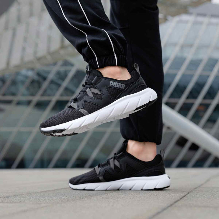 Puma black sports shoes with grey stripes and white sole, suitable for both men and women.