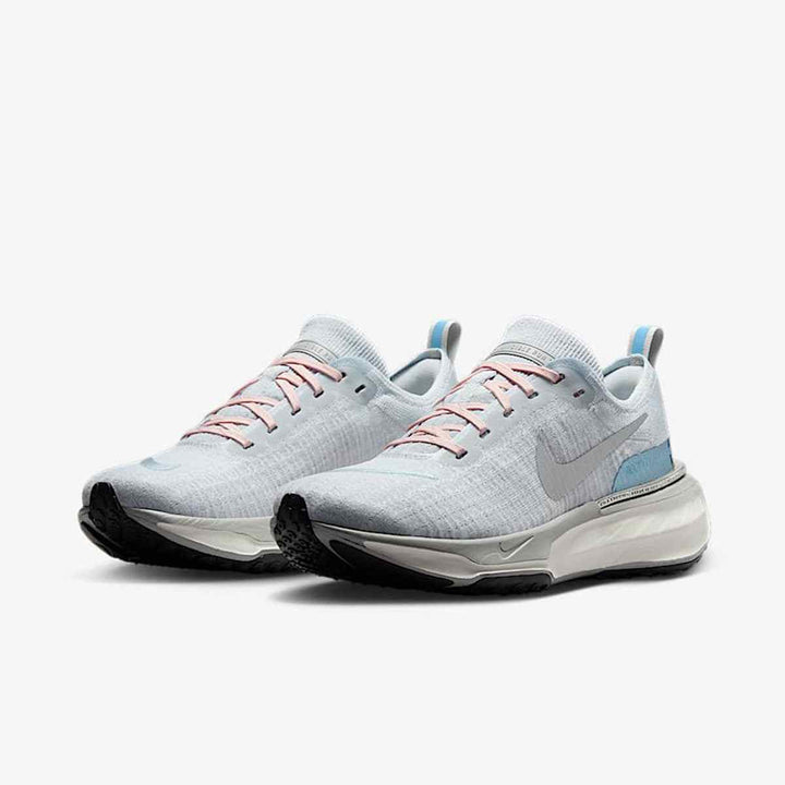 Light blue Nike ZoomX Vaporfly shoes with mesh upper and reflective logo, designed for exceptional lightness and performance in running.