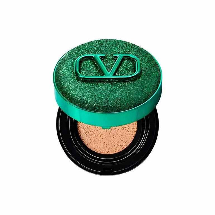 Valentino Beauty Limited Green foundation cream in a shiny green compact with logo.