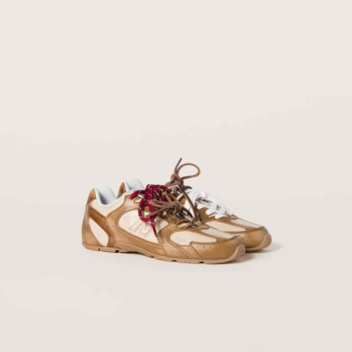 New Balance X Miu Miu 530 SL calf leather sneakers with dual-tone design and cotton-lace accents.