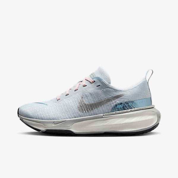 Light blue Nike ZoomX Vaporfly shoe with mesh upper and reflective logo for enhanced performance.