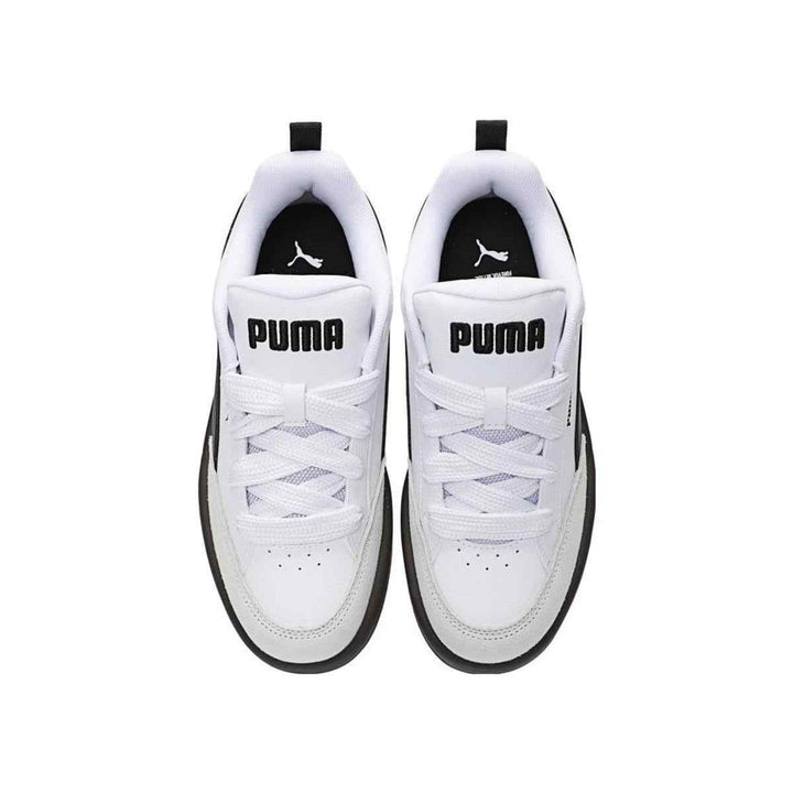 Puma white and black sneakers with wide rubber sole, top view.
