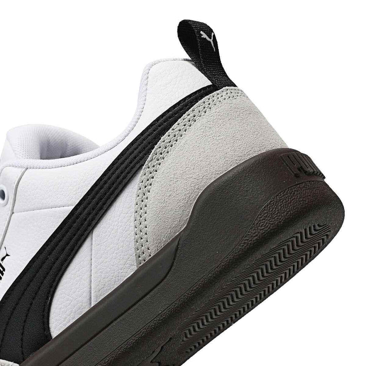 Puma sneakers in white and black with wide rubber sole.