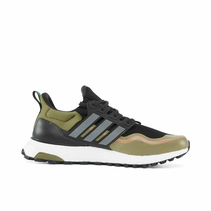 Trail running shoe with a sleek black, olive, and brown design, featuring Boost cushioning and Continental outsole for stability; made from recycled materials.