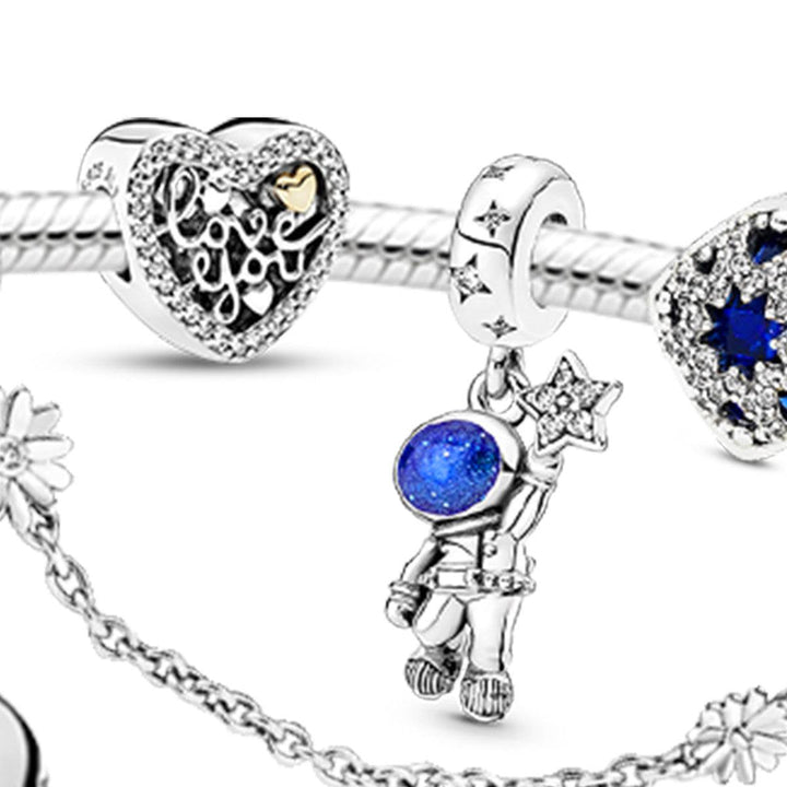 Elegant silver bracelet by PANDORA with enchanting frost flower designs and sparkling blue accents.