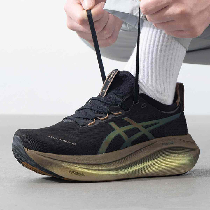 ASICS Gel-Nimbus 27 running shoe in black with bronze accents, featuring advanced cushioning and lightweight design.