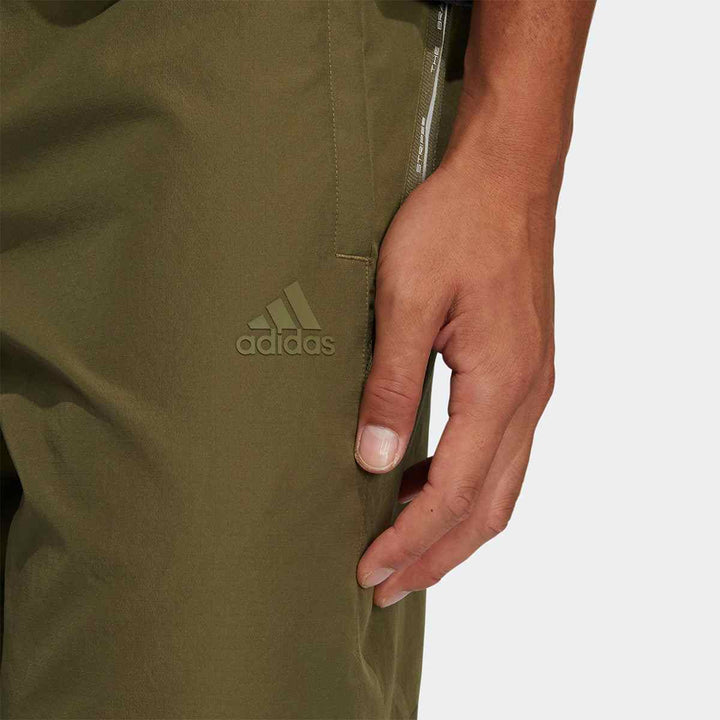 adidas men's breathable running pants in green, showcasing comfort and casual style.