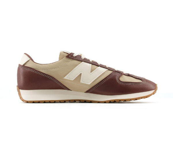 New Balance elegant brown unisex casual shoe with soft leather and beige fabric upper, white logo, and honey rubber sole