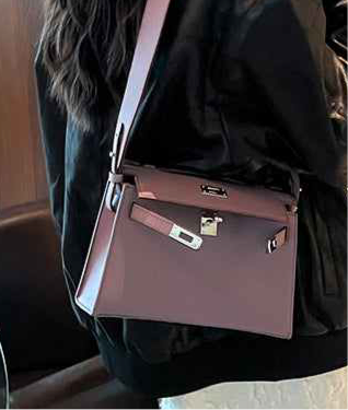 Racechoice Crossbody Bag in premium purple with wide strap worn over shoulder.