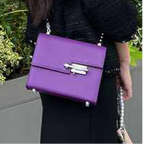 racechoice small square bag in purple with chain strap, worn as a casual messenger bag