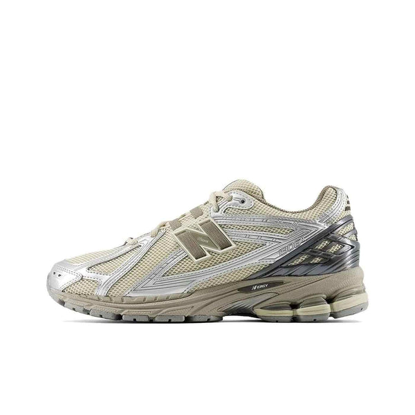 حذاء نيو بالانس Beige New Balance 1906R sneaker with silver accents, breathable mesh, and N-ERGY cushioned sole for comfort and support.