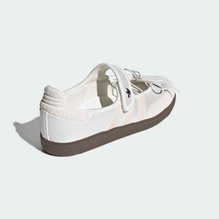 White and blush Adidas Samba Mary Jane sneaker with Velcro strap and chocolate rubber sole, featuring a classic leather upper and feminine design details.
