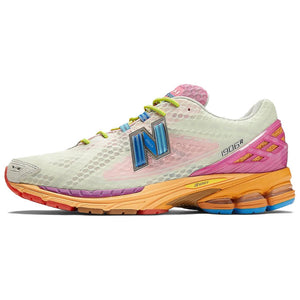 Lateral side profile of multicolor light green and pink New Balance shoes 1906R model, featuring pale green mesh uppers with pink base overlays, bright blue N-Lock lacing webbing, lime green laces, hot pink heel TPU support cage, and a multi-toned orange, yellow, and blue N-ergy cushioned midsole.
