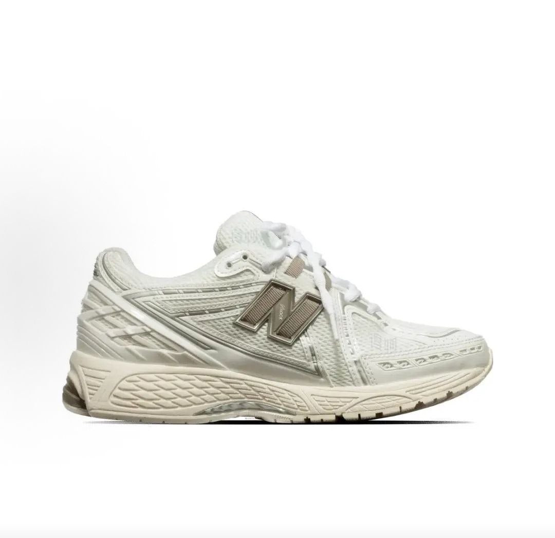 Medial side profile view of cream and off-white New Balance shoes 1906R.