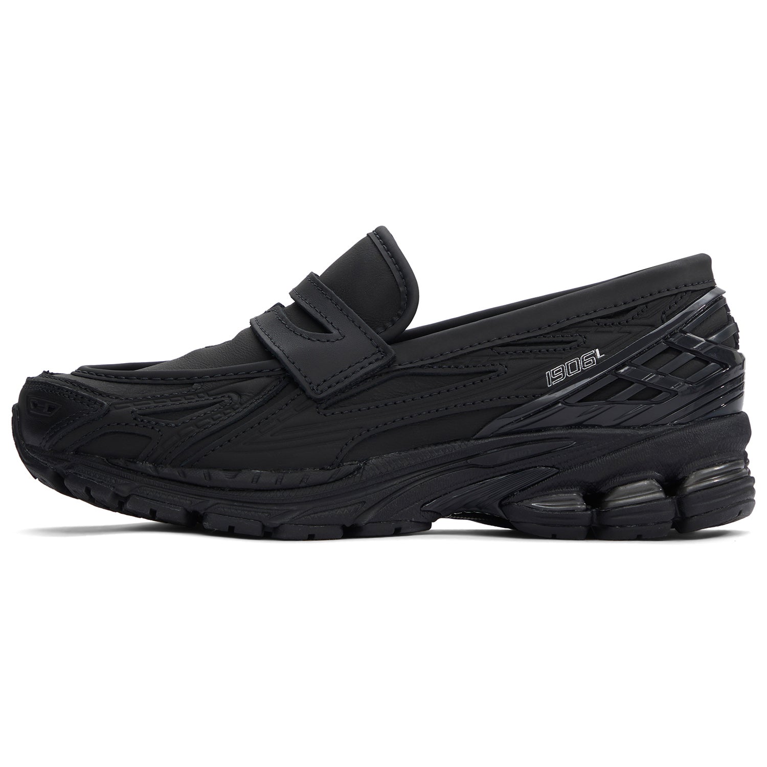 A lateral profile showcasing the New Balance 1906L Black Leather hybrid loafer with its smooth leather finish and refined upper structure.