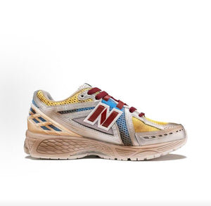New Balance 1906R shoes custom Gundam theme, medial side profile featuring anime cell-shaded line-art, multi-color mesh underlays, red N logo, and distressed cream midsole.