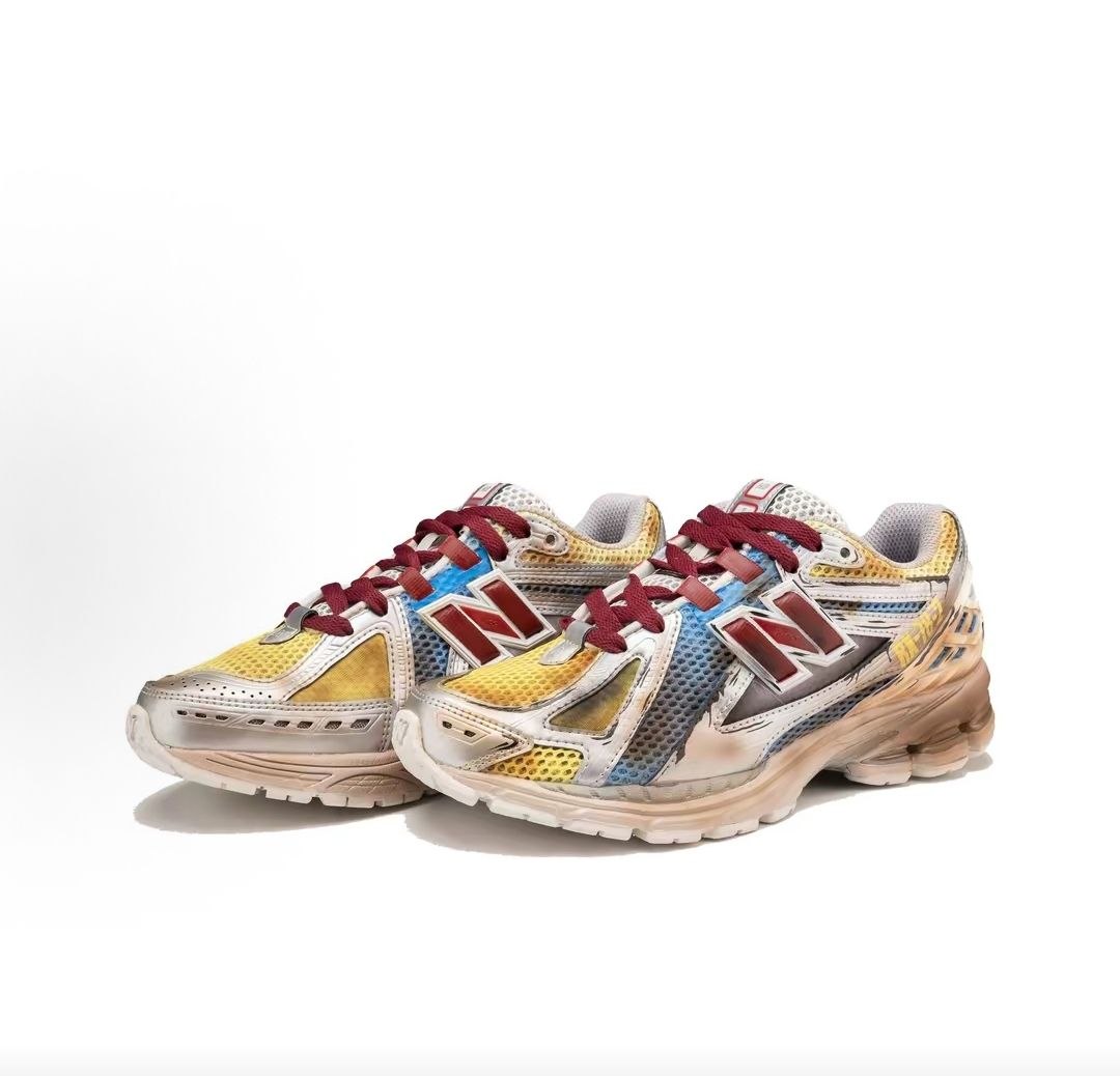 New Balance 1906R shoes custom Gundam theme, three-quarter pair product shot highlighting cell-shaded anime line-art, multi-colored mesh uppers, red N logos, and distressed soles.
