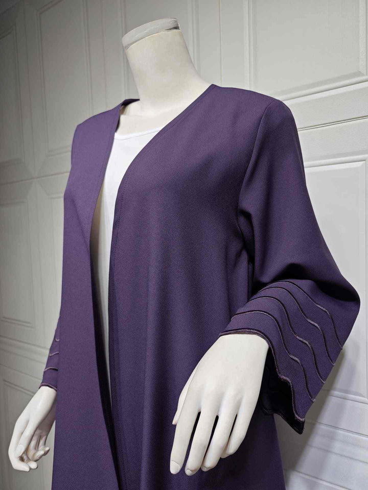 Exquisite modern abaya with wavy accents, luxurious fabric, and matching hijab.