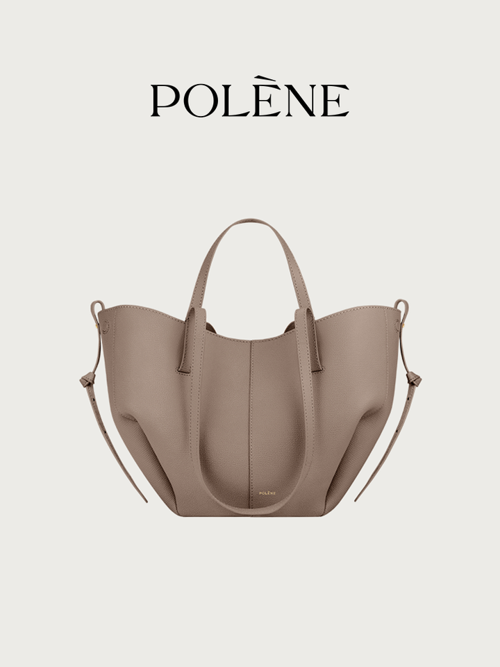 Polène Cyme Mini tote bag in camel litchi grain leather with soft curves and dual carry options.