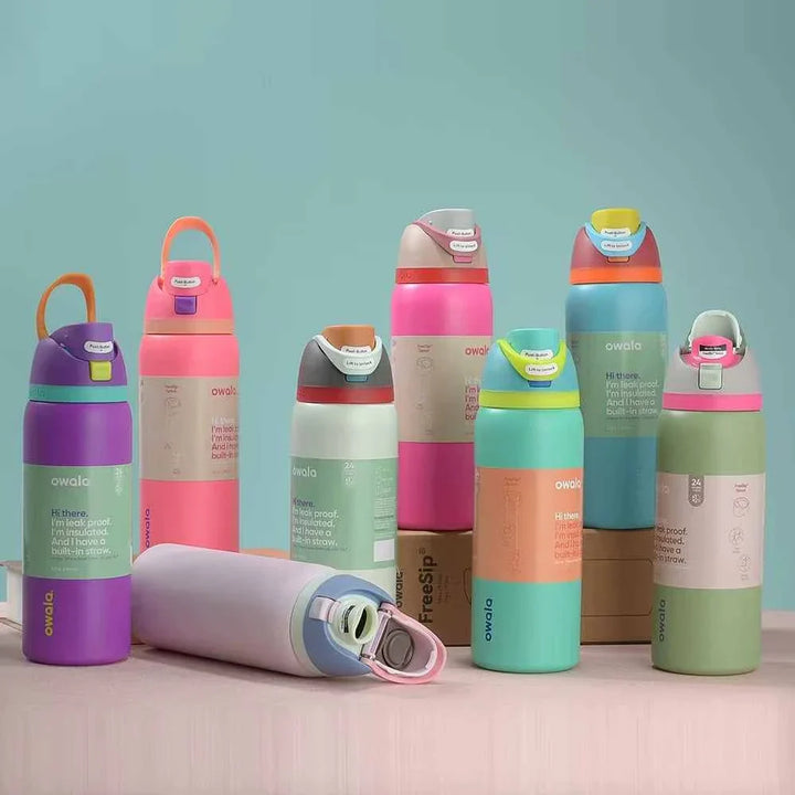Colorful Owala Thermos Cup collection with spill-proof lids and dual drinking options displayed on a pastel surface.