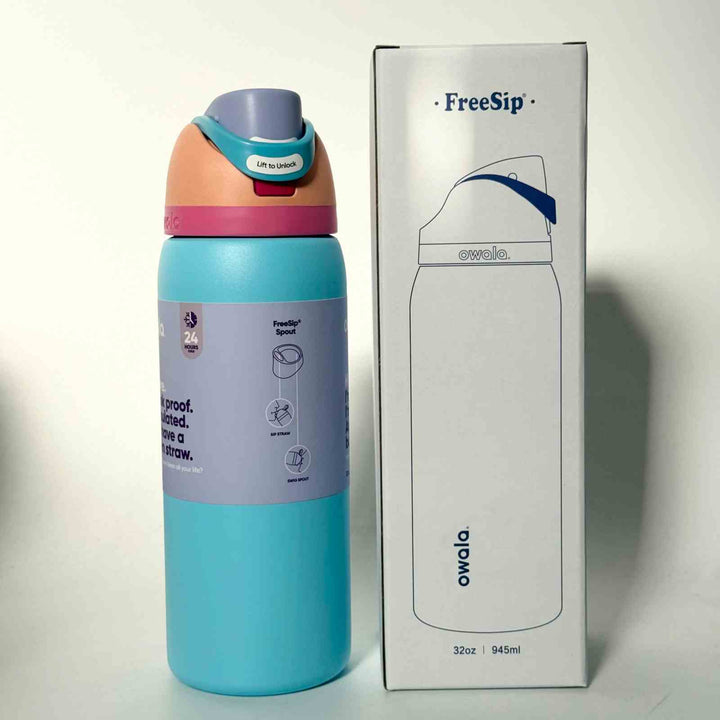 Owala FreeSip stainless steel water bottle with dual spout, leak-proof lid, and 24-hour insulation in blue and peach colors next to its packaging box