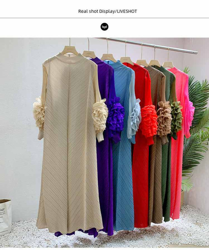 Solid color loose dress with floral adorned sleeves in various colors hanging on a rack.