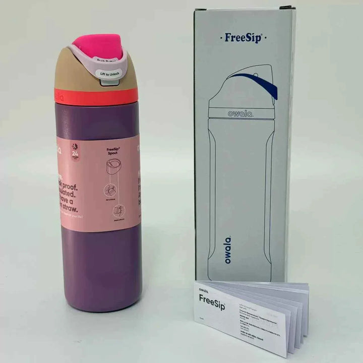 Purple Owala FreeSip stainless steel water bottle with leak-proof dual spout and protective lid next to its packaging box and instruction manual