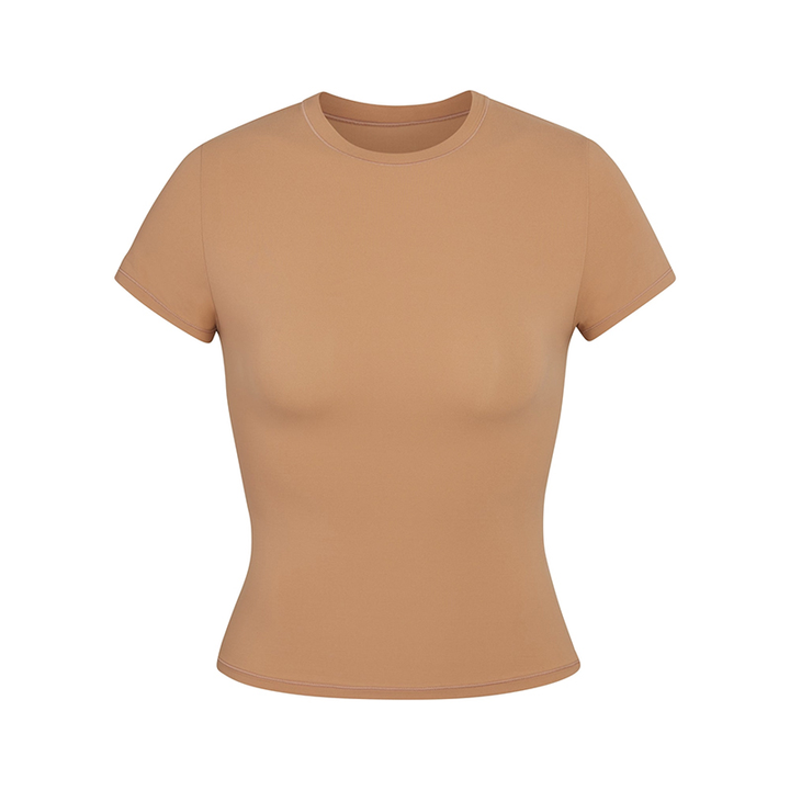 Skims short sleeve slimming shapewear t-shirt in tan with crew neck and stretchy fabric.