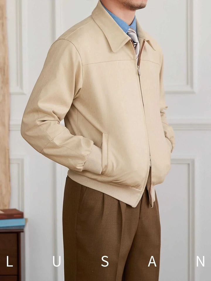 Beige Mr. Lu San's men's casual جاكيت with ribbed cuffs and side pockets, classic collar, and zipper closure, styled with brown pants.
