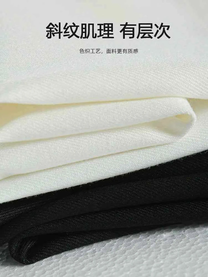 Close-up of luxurious fabric texture for classic comfortable formal pants in white and black colors