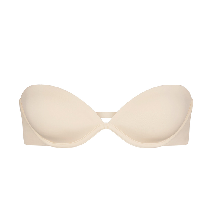 SKIMS multi-way strapless bra in creamy white with smooth finish and adjustable detachable straps for versatile wear and natural lift.