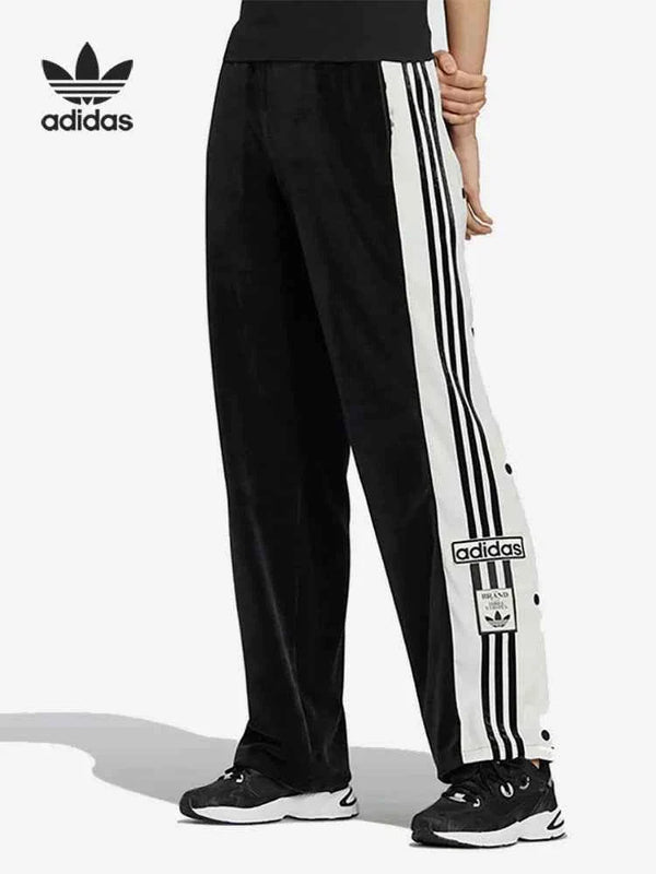 أديداس Adidas black sports pants with classic design, white side stripes, and snap buttons for easy wear