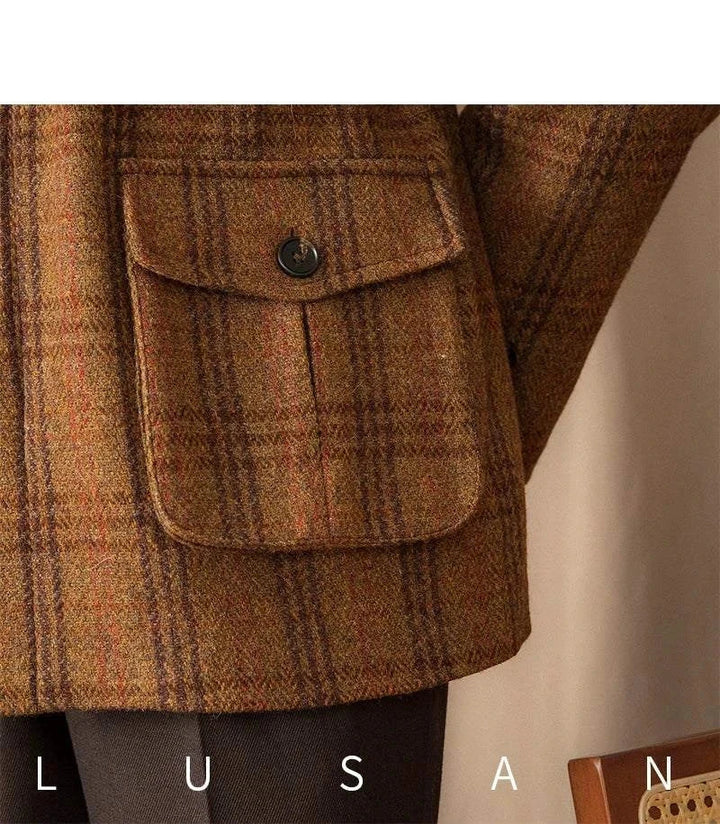 Close-up of brown and orange checkered thick wool tweed fabric with buttoned flap pocket on Mr. Lusan hunting tweed jacket