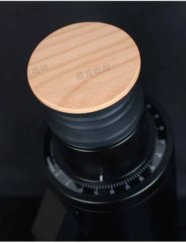 electric coffee grinder with wooden lid and black body with adjustable speed settings