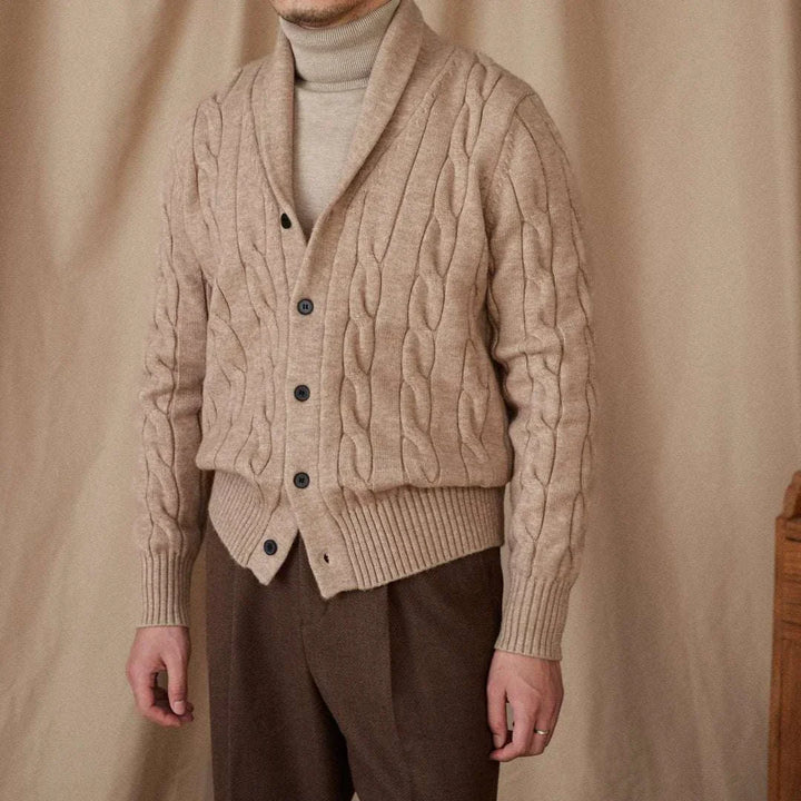 Mr. Lusan cardigan beige cable knit shawl collar with buttons and ribbed edges worn over turtleneck