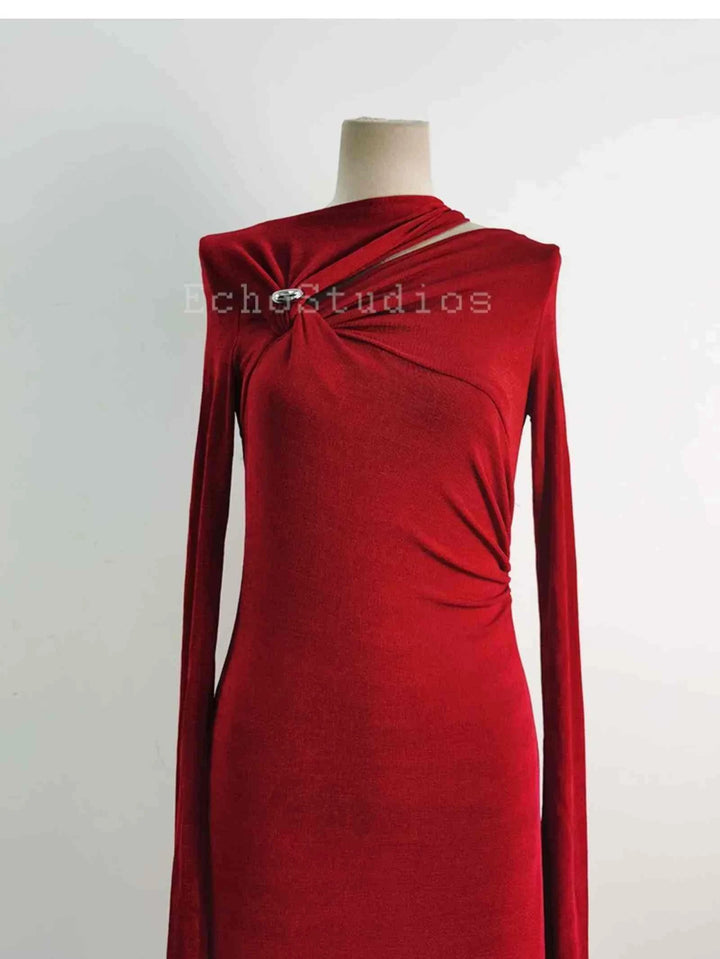 Elegant red long sleeve evening maxi dress with draped design and silver pin detail