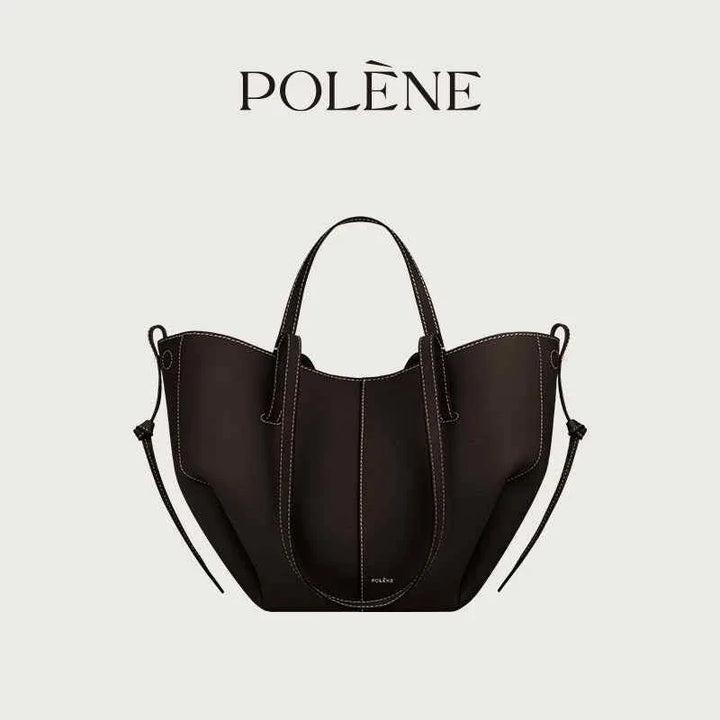 Black Polène Cyme Mini tote bag with smooth curves, leather texture, dual-use design, and top handles.