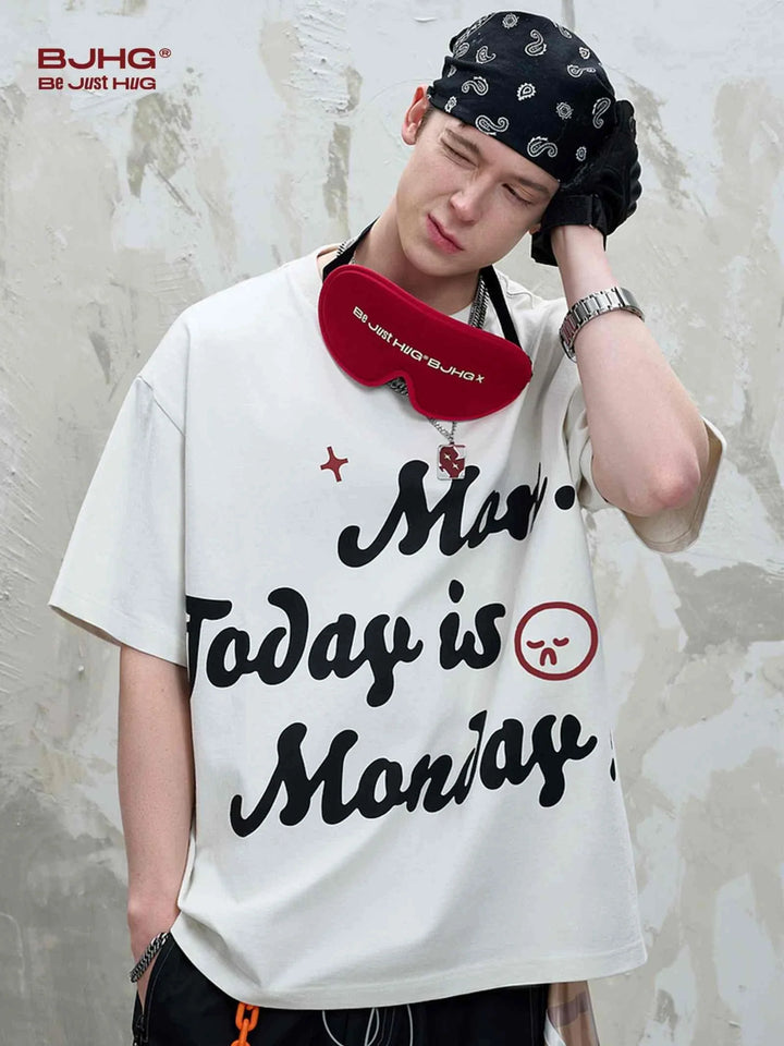 Young man wearing white تيشيرت مطبوع بشعار Mom Day is Friday with black headscarf and red headphones around neck